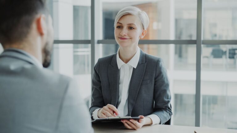 Faq 2 AI in HR: recruiter interviewing a candidate in a modern Bangladeshi office