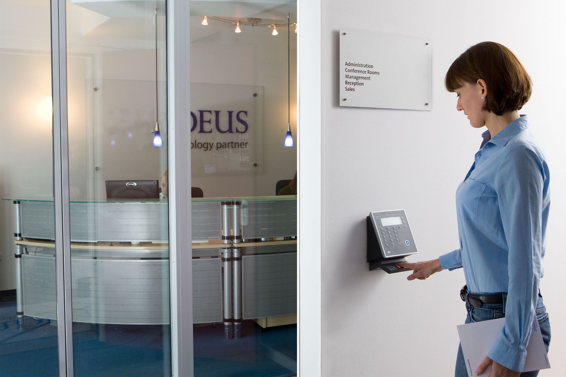 Choosing right device each site type: employee using a wall-mounted biometric attendance device in an office