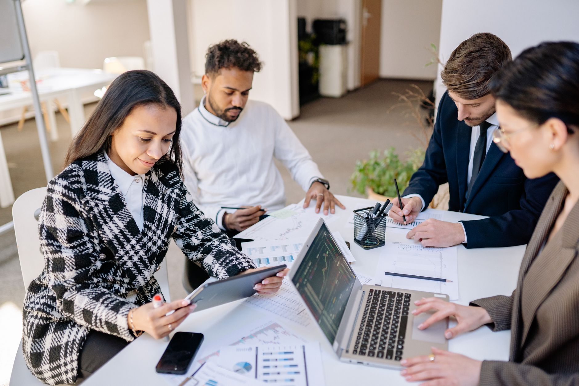 high staff turnover track properly: an HR team reviewing workforce and attendance data in a modern office