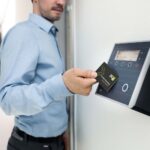 Rfid Attendance System: How Rfid &Amp;Amp; Nfc Cards Really Work 3 RFID attendance system: employee tapping a card on a wall-mounted attendance terminal
